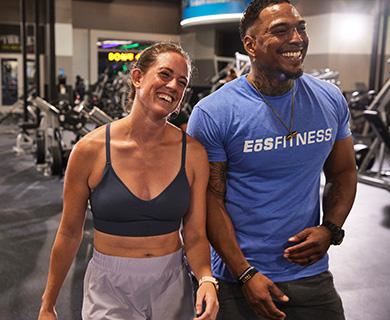 two smiling eos gym members wearing athletic clothes