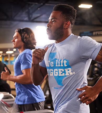 two eos members on cardio equipment running