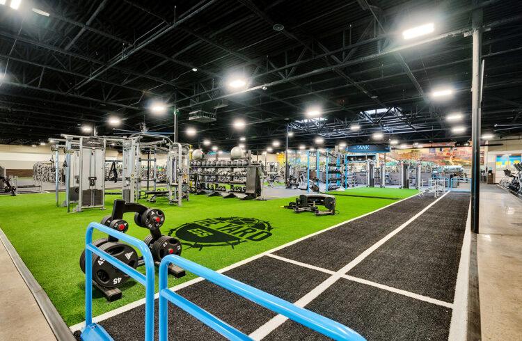 a wide shot of the inside of a eos gym showing off several machines and amenities