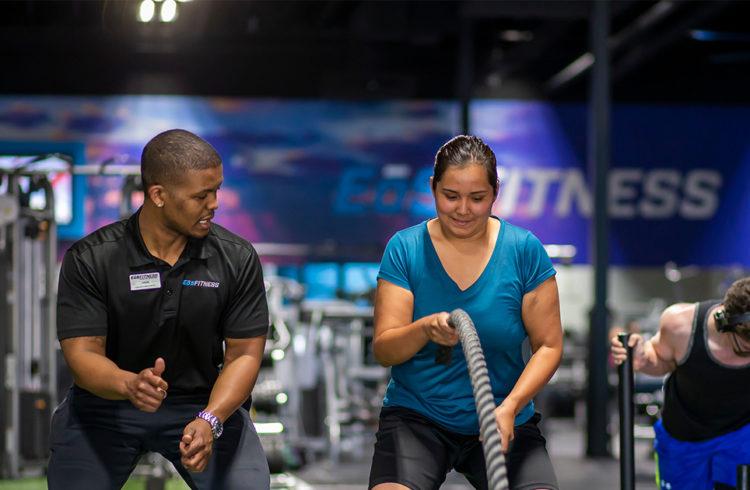 eos gym member working with Personal Trainer in a modern box gym