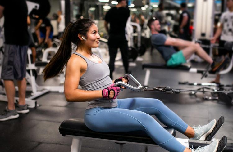 athletic eos gym member doing cable arms exercise
