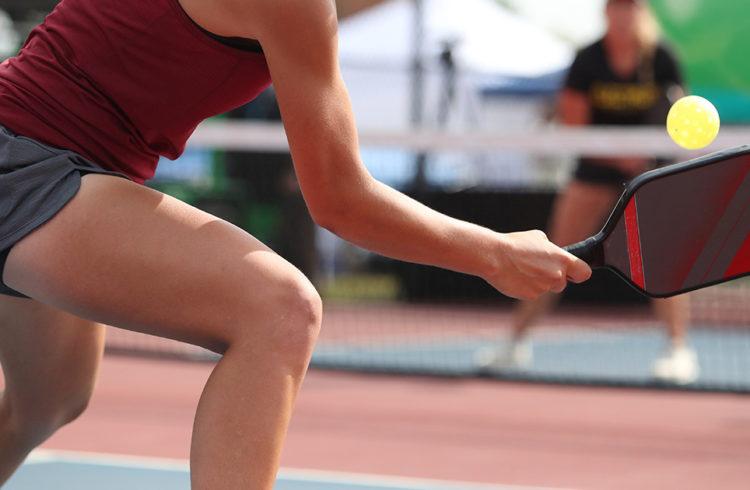 two pickleball player playing on an outdoor court