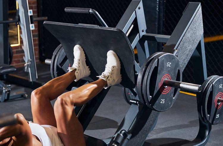 women using leg press machine for workout