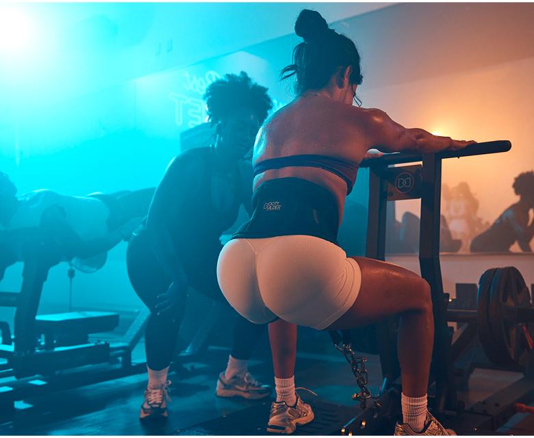 eos gym members on the belt squat machine