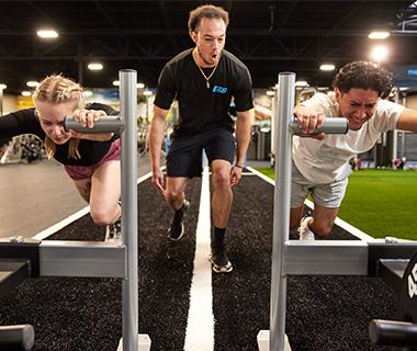 personal trainer helping eos gym member with exercise