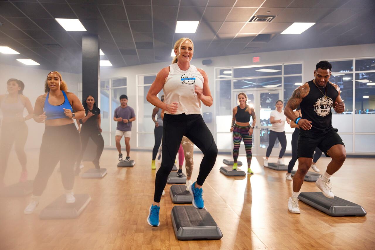 group of athletic eos gym members in a step class