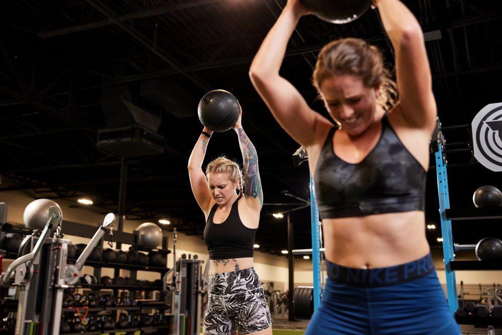 two eos gym members doing a challenging workout