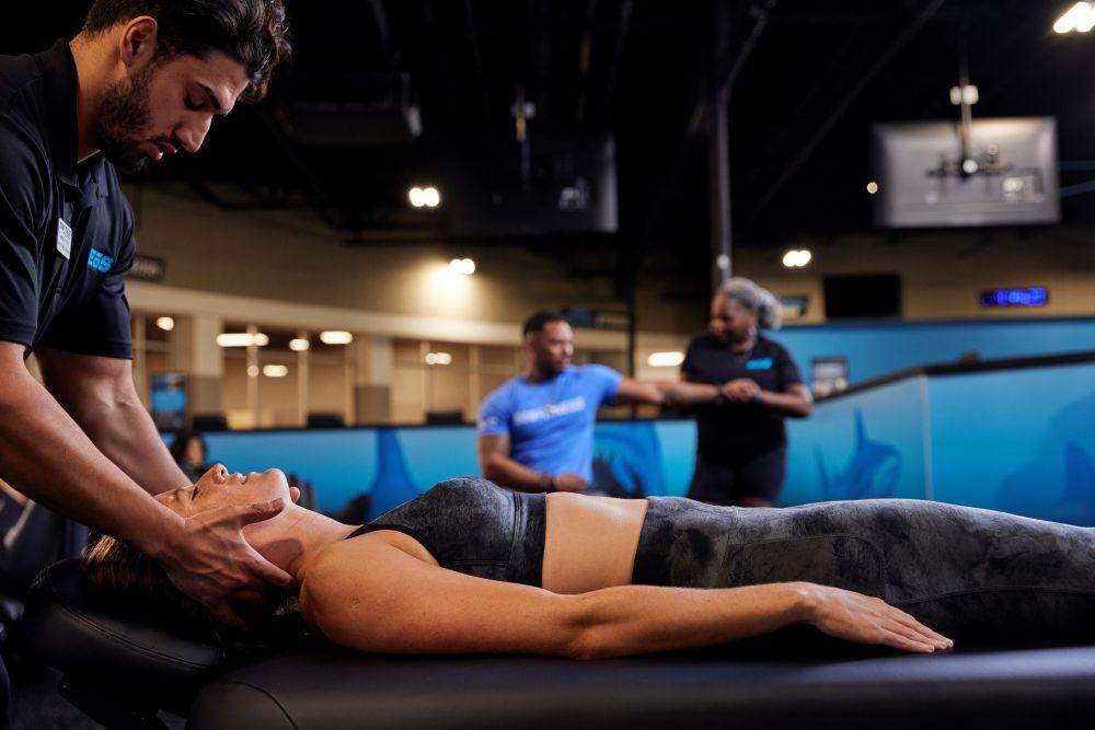 eos gym member getting massaged by staff