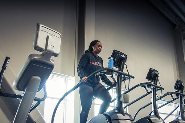 eos gym member doing a challenging workout on a stair stepper machine