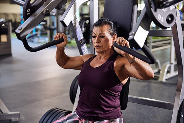 eos gym member using a chest press machine to workout