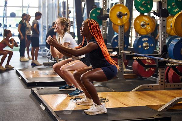 a few teen eos gym members doing squats