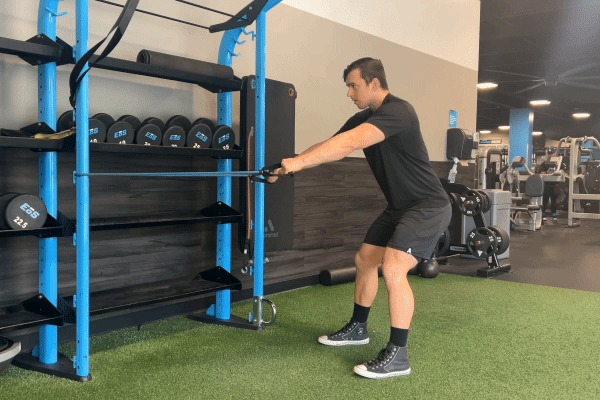 eos gym member doing cable band rows