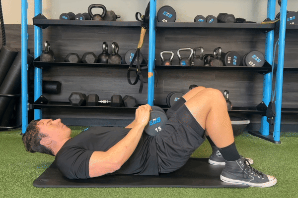 eos gym member doing a glute bridge with weight