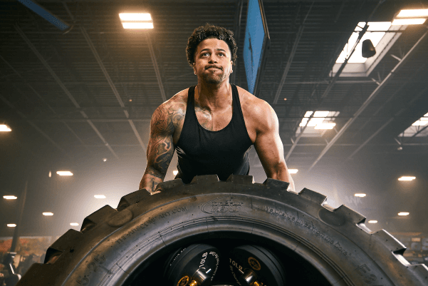 eos gym member flipping a tire