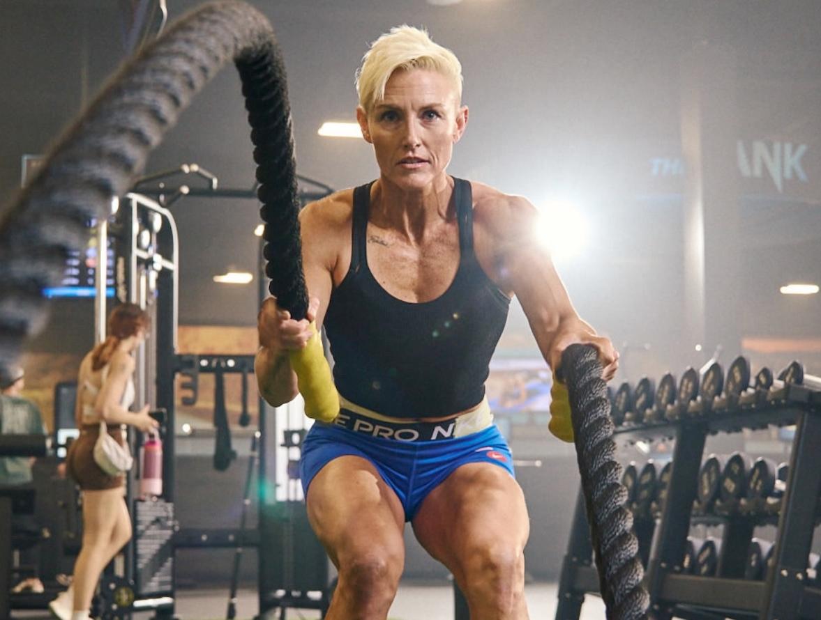 eos gym member working the battle ropes