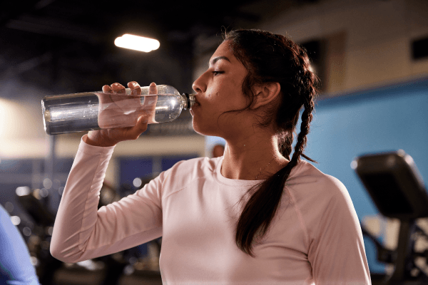 eos gym member drinking water during workout