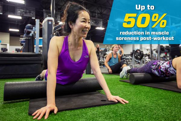 eos gym member foam rolling on indoor turf