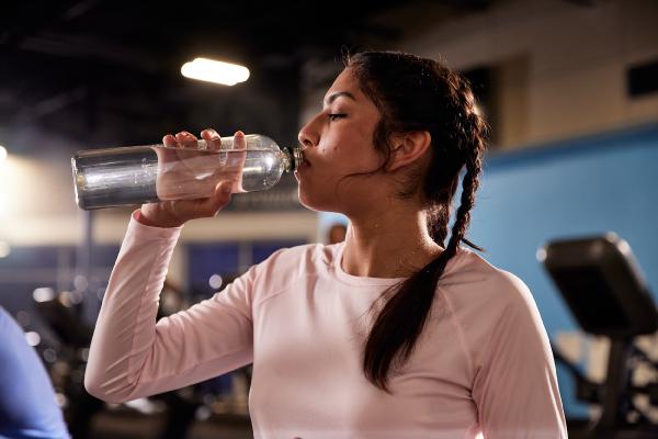 eos gym member drinking water before a workout