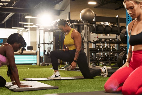 eos gym members on yoga mats working out and stretching