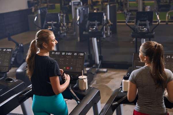 two eos gym members walking on the treadmill