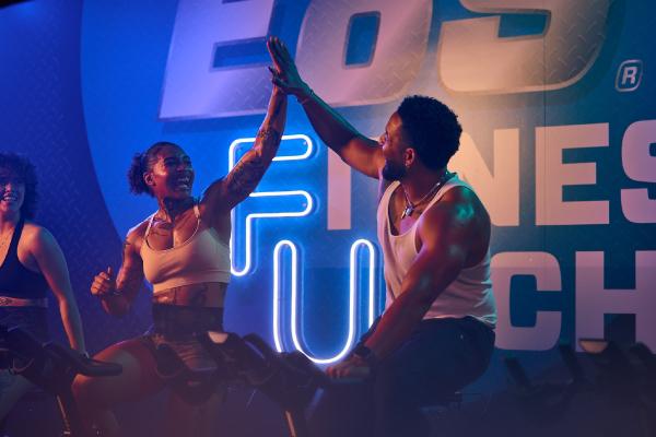 two eos gym members high fiving after a workout
