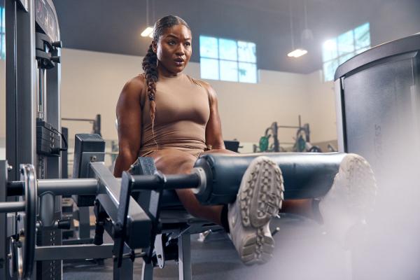 eos gym member doing leg strength exercises on equipment