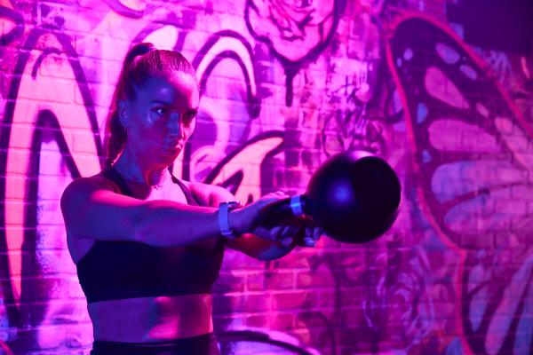 close up shot of eos gym member preforming a kettlebell swing