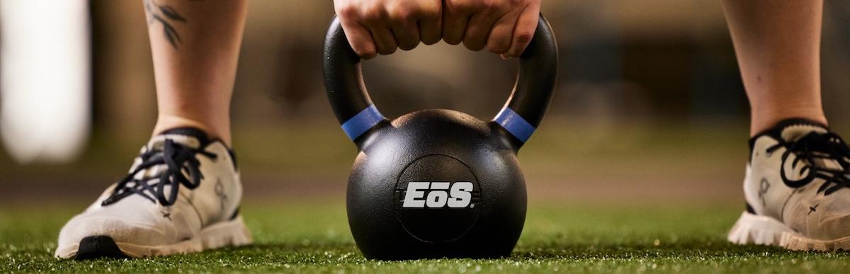 close up shot of a modern eos kettlebell on indoor turf