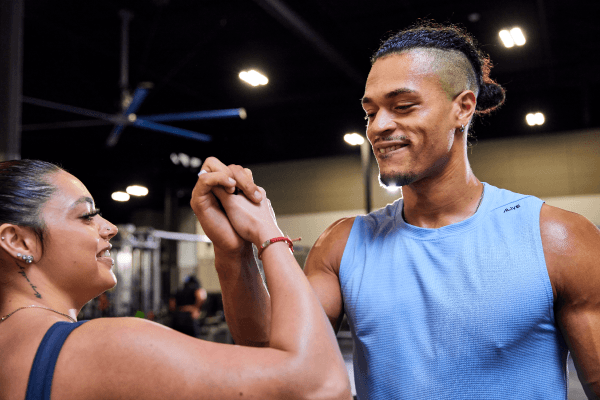two eos gym members fist bumping