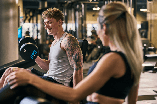two eos gym members working out with one another