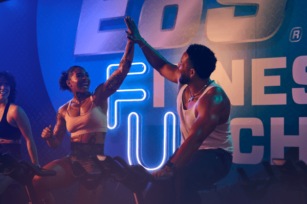 two eos gym members high fiving after a workout
