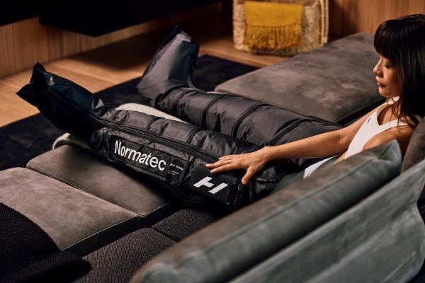 eos gym member using the hyerice boots for recovery