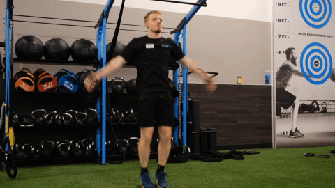 eos gym member doing jumping jacks