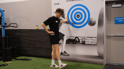 eos gym member doing leg swings