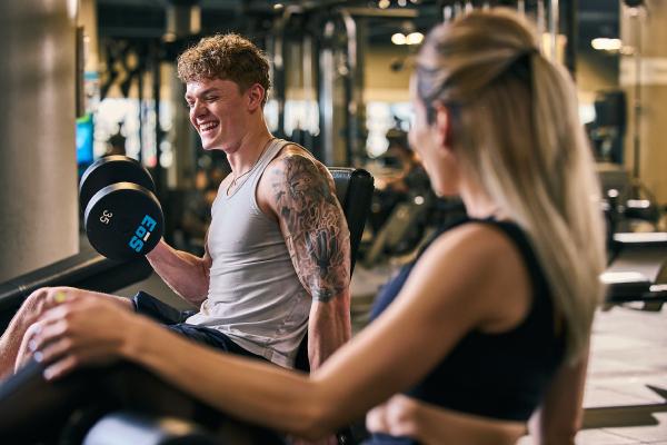 two eos gym members working out with one another