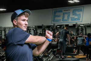 eos fitness gym member performing a dynamic stretch