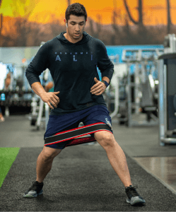 eos fitness gym member performing a dynamic stretch