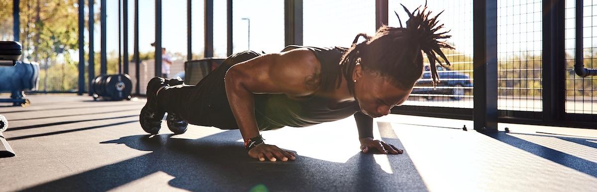 eos gym member doing push ups in the backyard