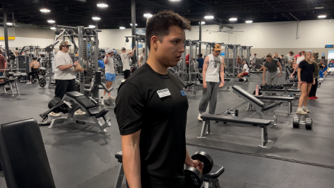 eos fitness member doing dumbbell bicep curls