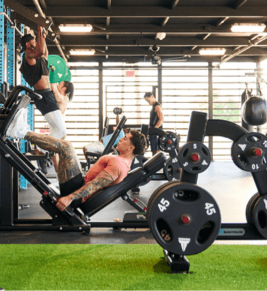 eos gym members working out in the backyard amenity