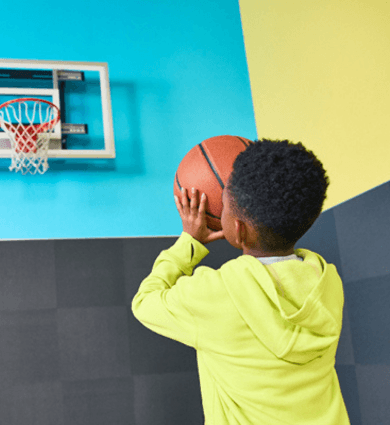 Kiddo at EōS Kids’ Club playing basketball