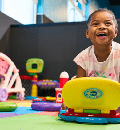 Child playing with toys in the EōS Kids’ Club daycare