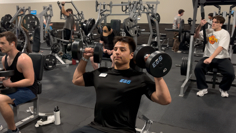 eos fitness member doing seated dumbbell shoulder press