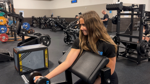 eos fitness member performing isometric bicep curls