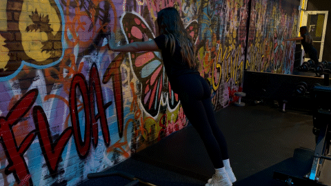 eos fitness member performing an isometric wall push
