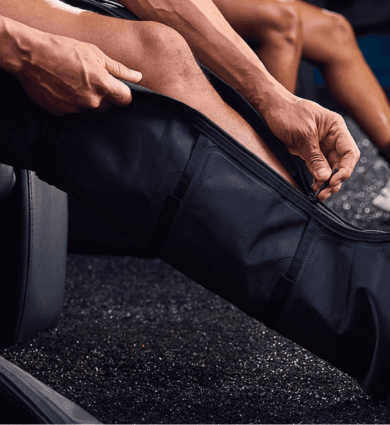 eos fitness member using compression boots for recovery