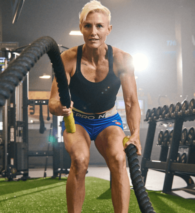 eos fitness member using battle ropes in the gym