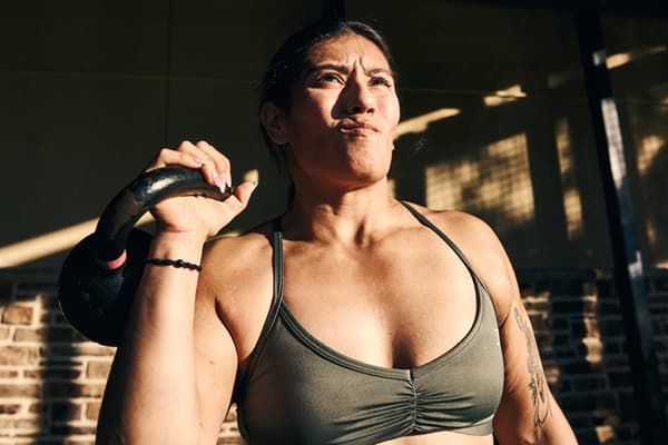 eos fitness member working out with a kettlebell