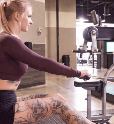 eos fitness member using the rowing machine at eos fitness