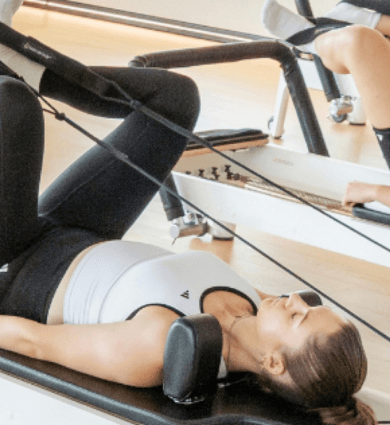 eos fitness members doing pilates on a reformer